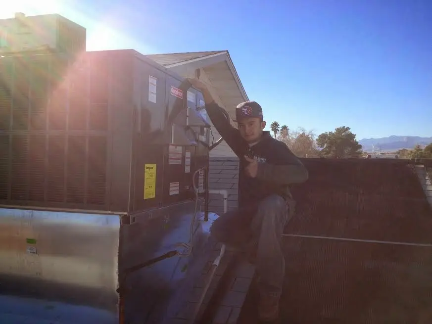 HVAC technician performing Boiler Repair on a rooftop unit in Land O' Lakes